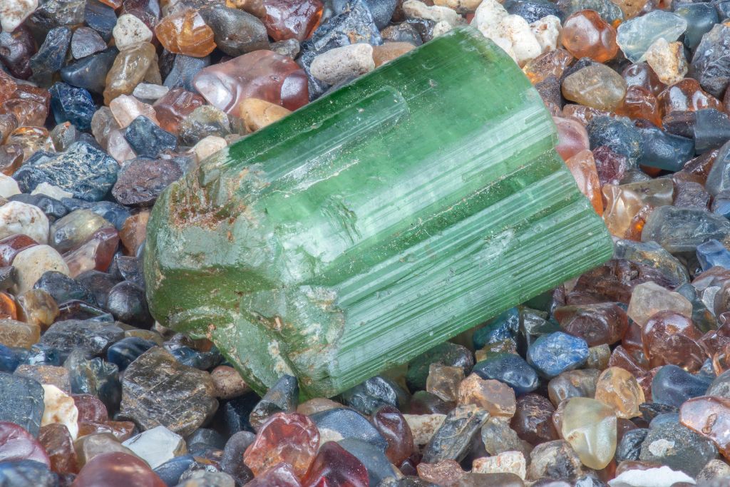 an elbaite tourmaline crystal on a pebbles