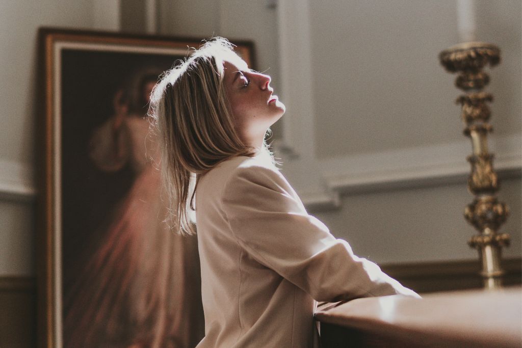 A woman kneeling in the church