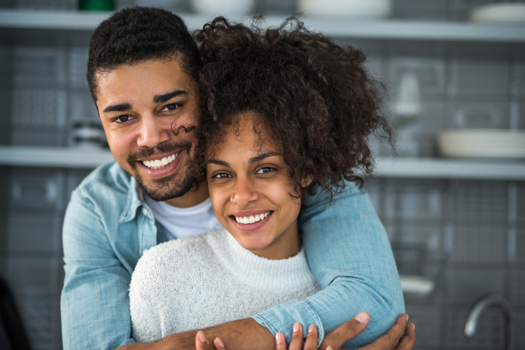 A man hugging a woman