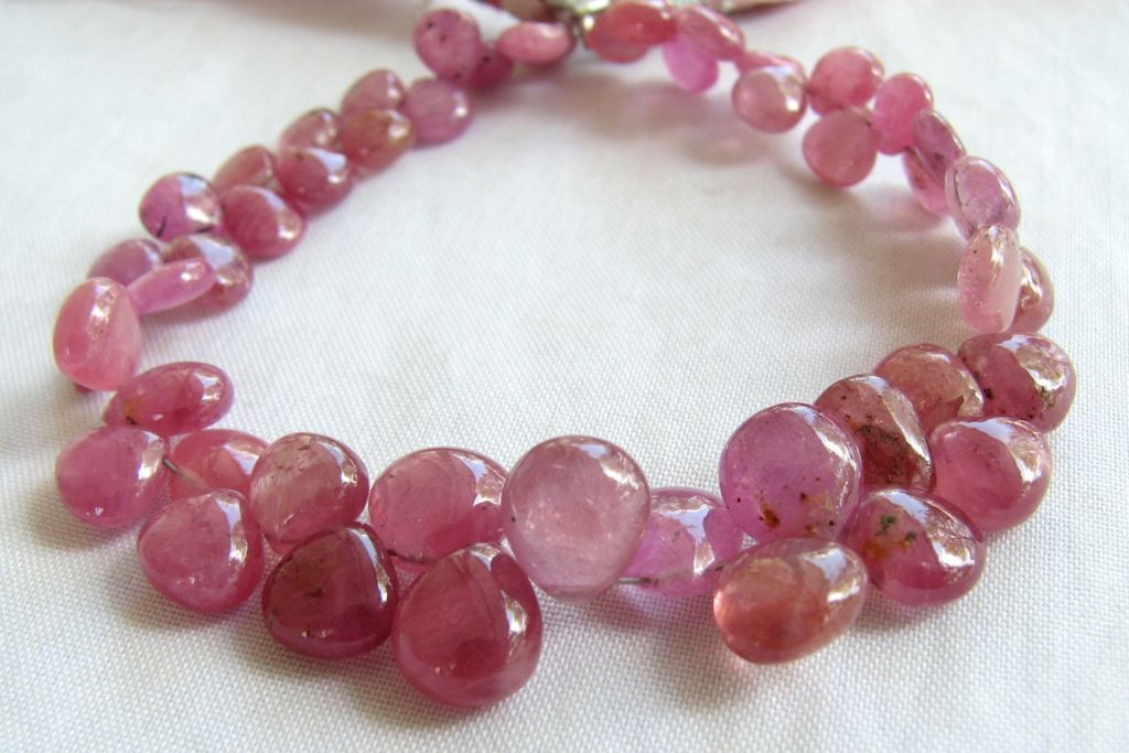 Faceted Onion shaped Pink sapphire beads on a string of wire with tussle on the end