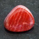 polished Red Jasper on a dark marble table