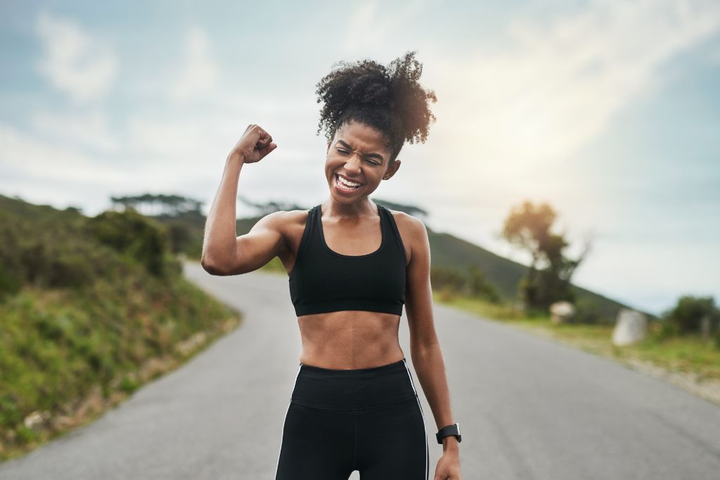 woman flexing her arms on the road