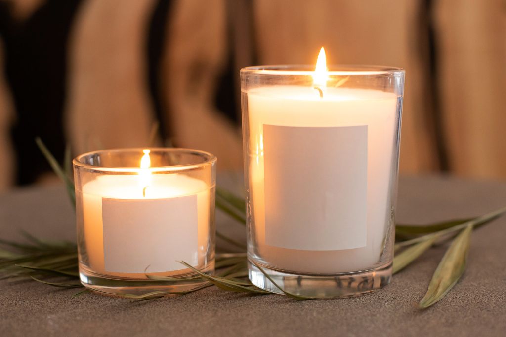 two candles on a glass