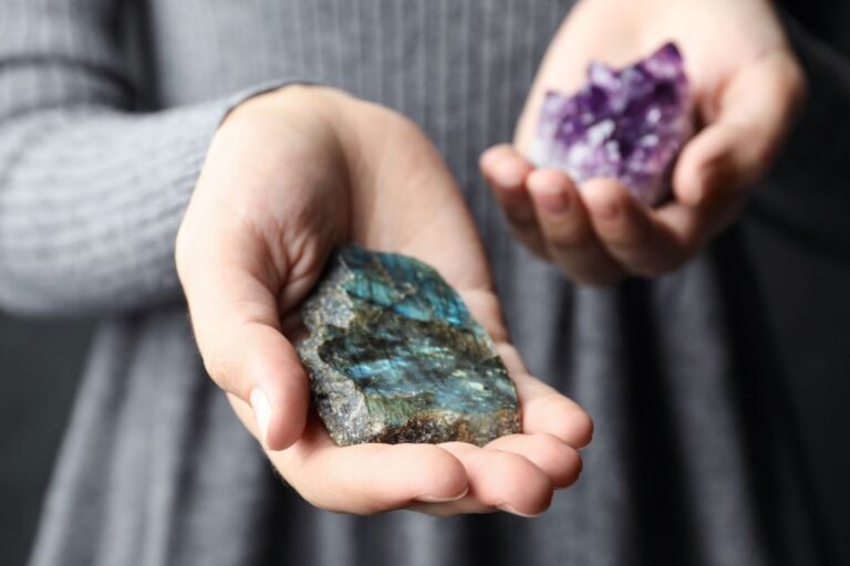 a woman holding crystal on both hands