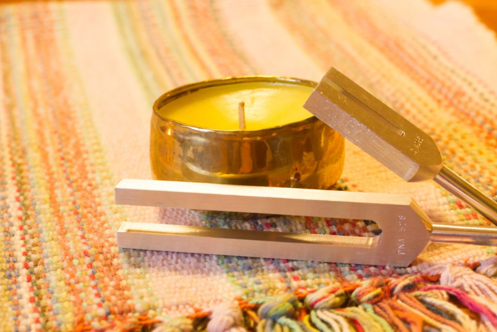 A tuning fork on a candle and cloth