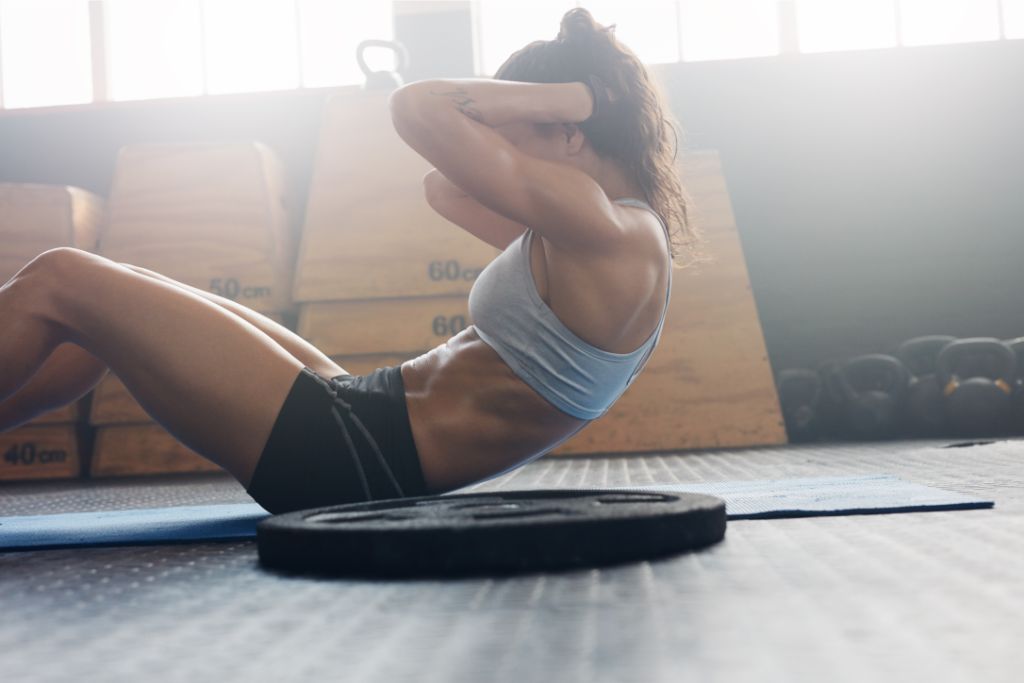 A woman is working out in the gym.