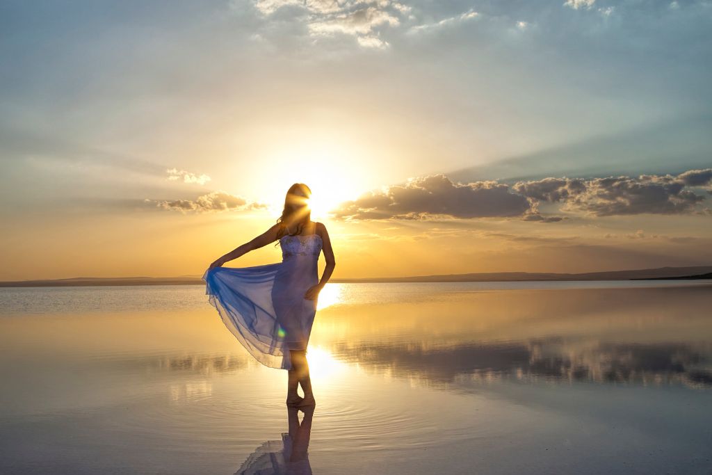 A woman is standing on the sea