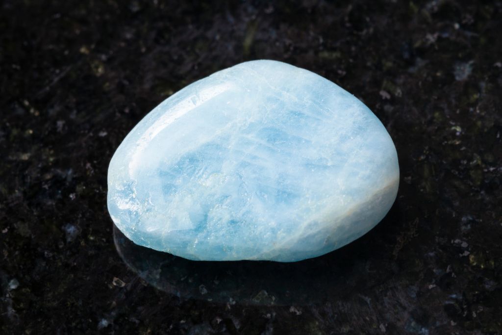 Aquamarine on a black granite