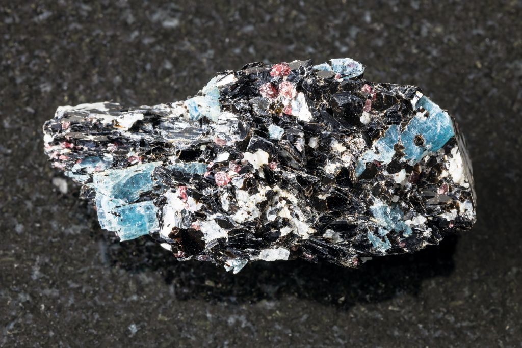 A biotite with Kyanite crystal on a black granite