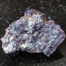 A Cuprite crystal on a black granite