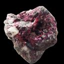 An Erythrite crystal on a black background