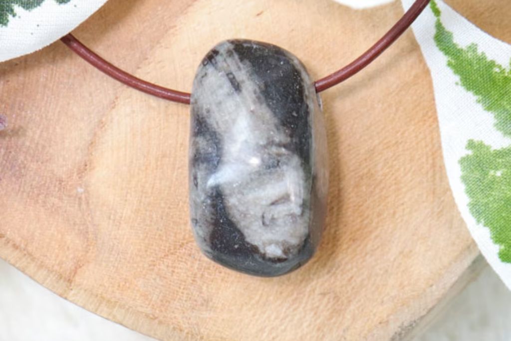 A Frosterley Marble Necklace on a wood. Source: Etsy | CrystalCaveCo