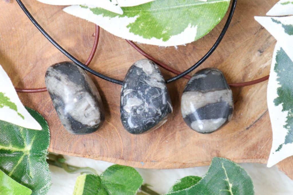 A Frosterley Marble Necklace on a wood. Source: Etsy | CrystalCaveCo