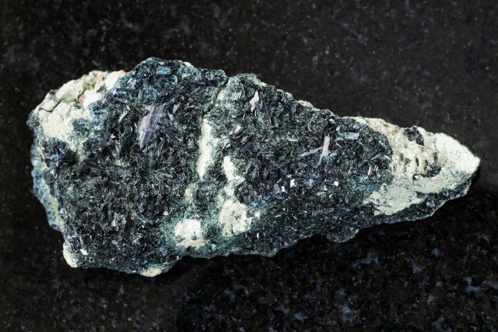Hornblende crystal on rough amphibole rock
