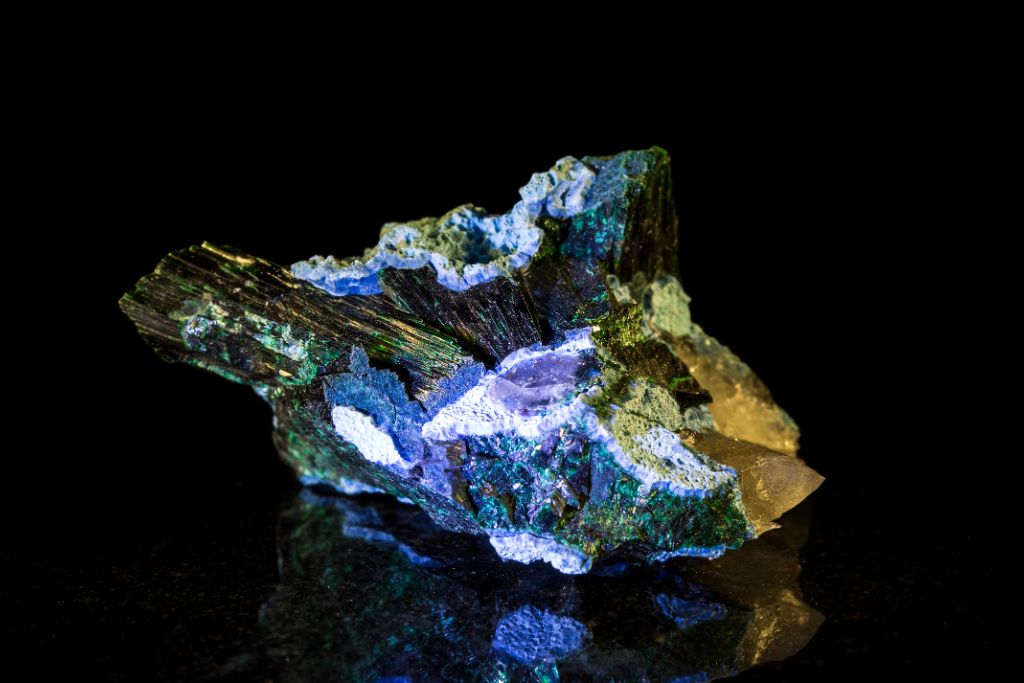 A Plancheite crystal on a black reflective background