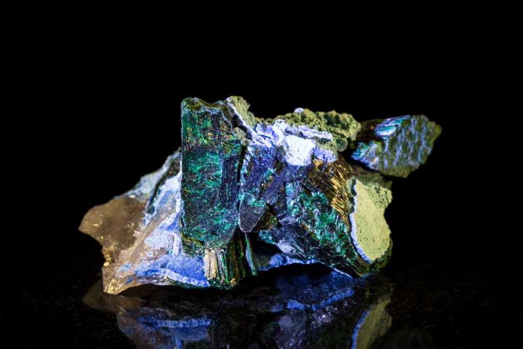 A Plancheite crystal on a black reflective background