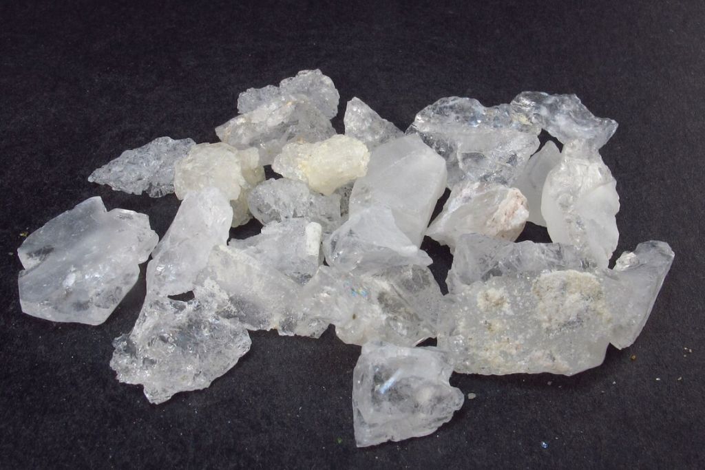 Different cuts of Pollucite crystal on a greyish background. Source: Etsy | TheGlobalStone