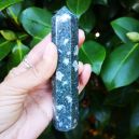 A person holding a Preseli Bluestone wand. Source: Etsy | ShopYoniverse