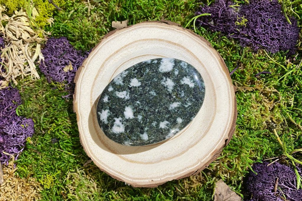 A Preseli Bluestone on a wood. Source: Etsy | TripleGoddessReiki