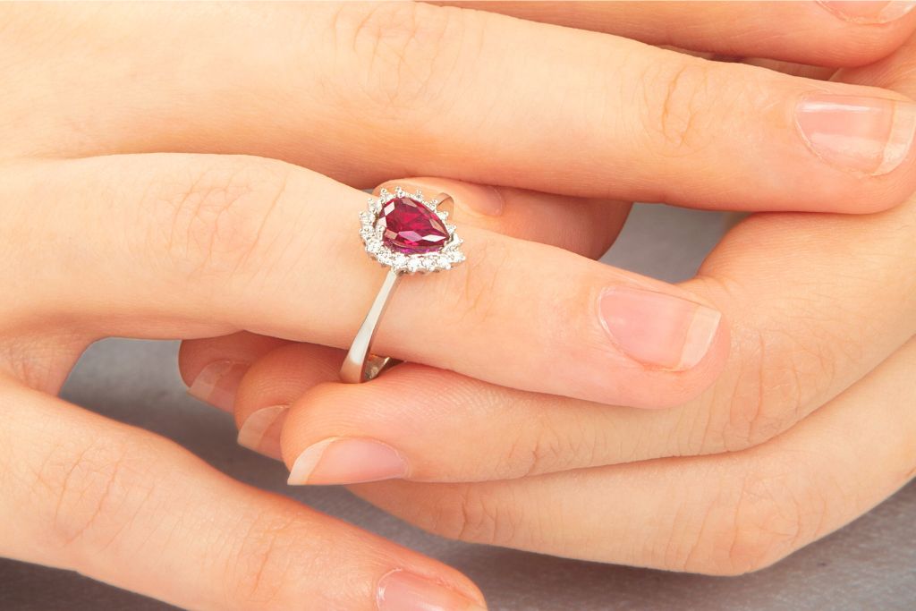 Ruby ring worn by a woman on her middle finger