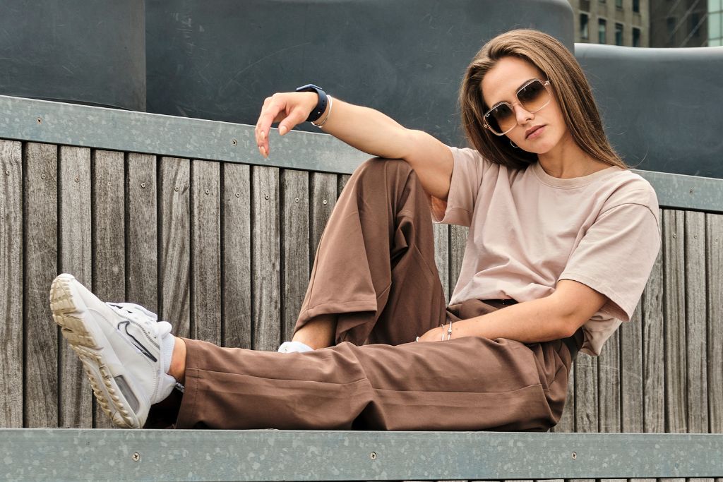 a woman wearing brown colored pants and shirt