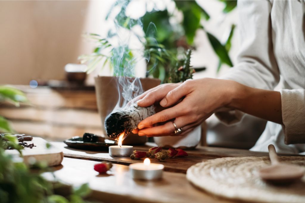 hands burning white sage for spiritual ritual