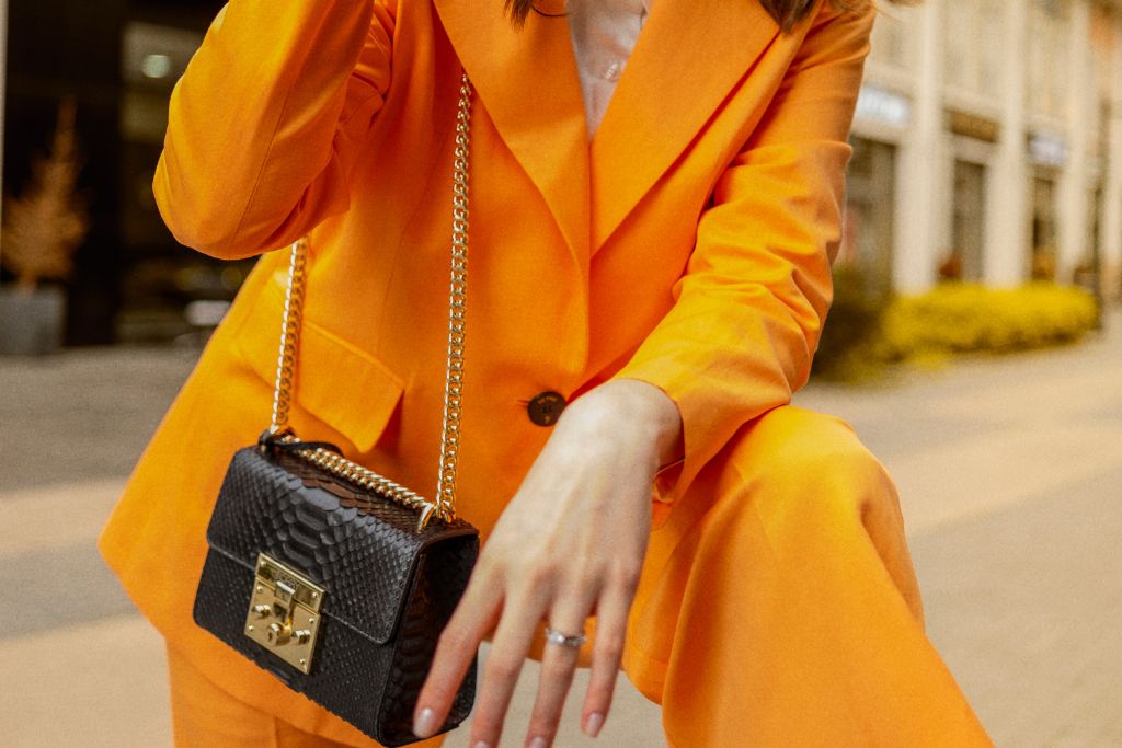 woman wearing an orange blazer and pants