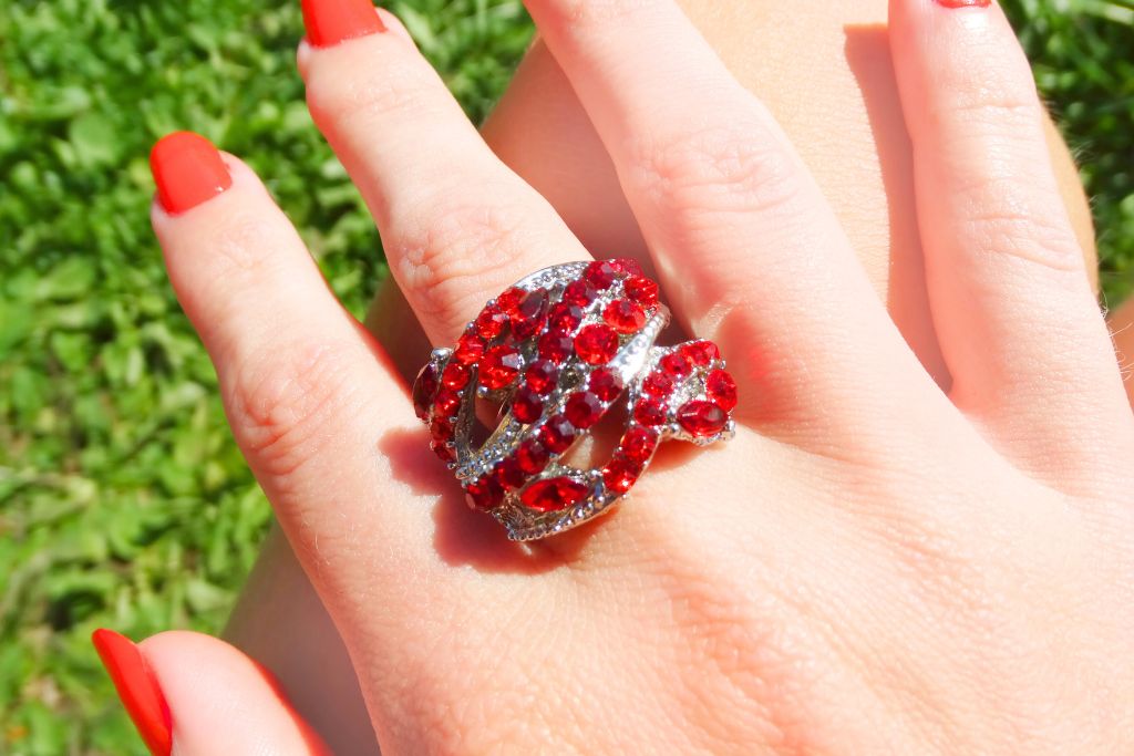 Ruby ring worn by a woman on her middle finger