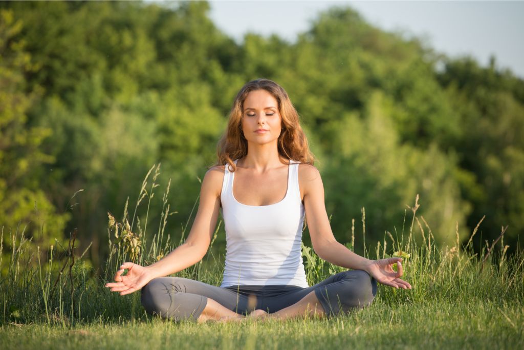 woman doing meditation in an outdoor setting