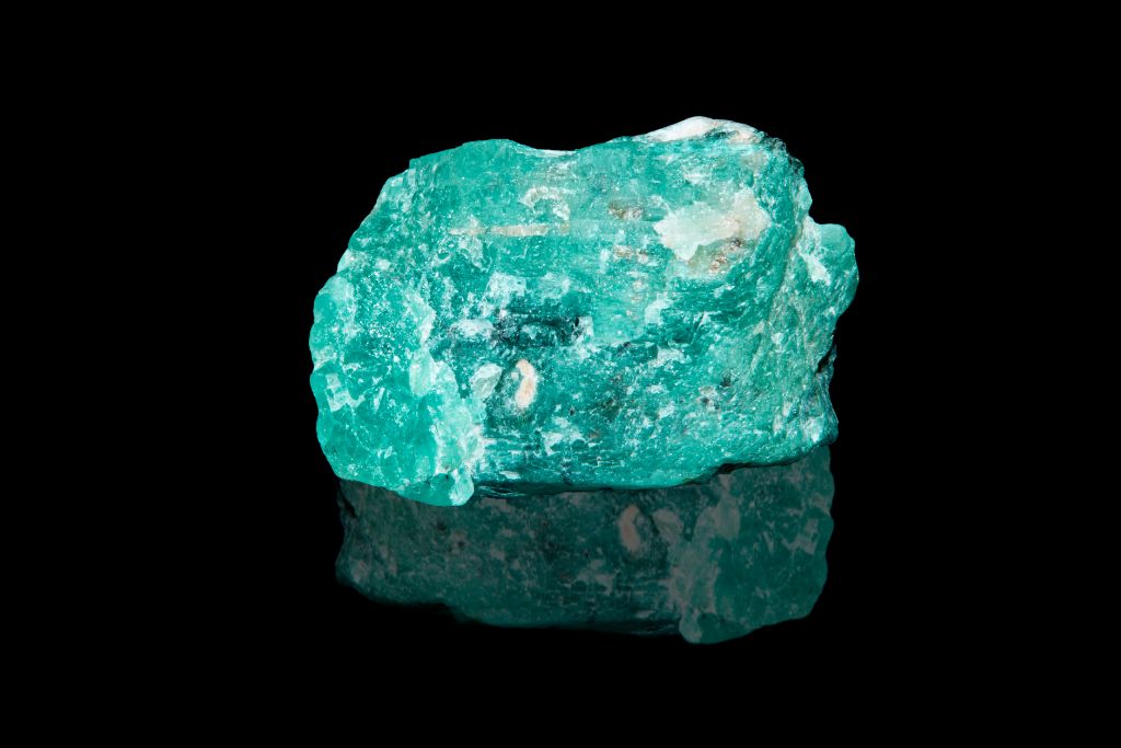 Grandidierite on dark background. Image Source: Flickr | Gerald Armstrong