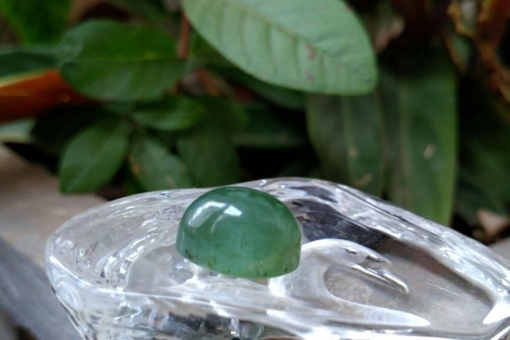 polished grandidierite placed on top of glass surface