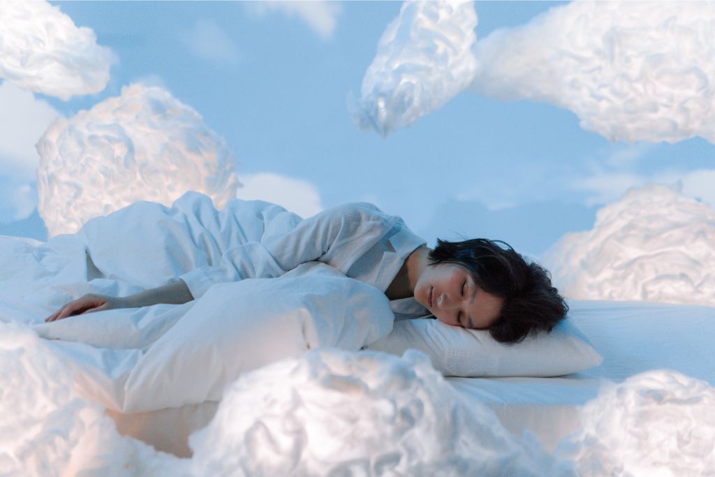 Woman sleeping near fluffy clouds