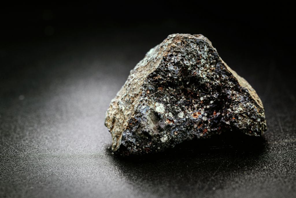 A Pyrolusite crystal on a dark background