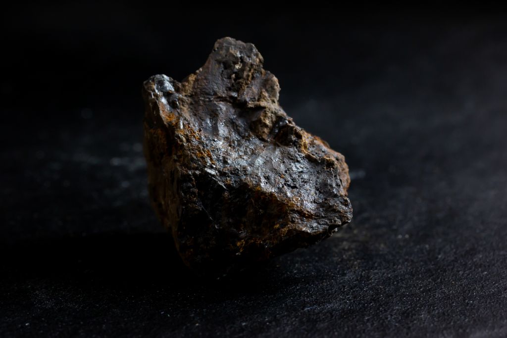 A Pyrolusite crystal on a dark background