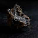 A Pyrolusite crystal on a dark background