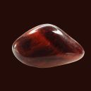 Red Tiger’s Eye crystal on a black background