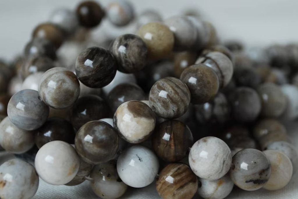 Silver Leaf Jasper beaded necklace on a white table