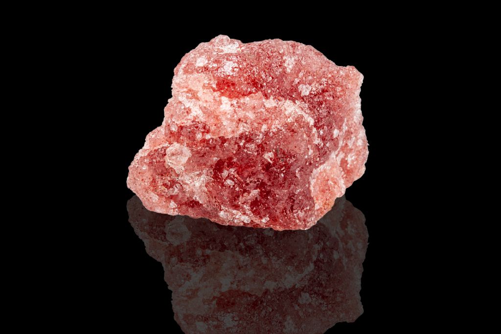 Strawberry Quartz on a black reflective background