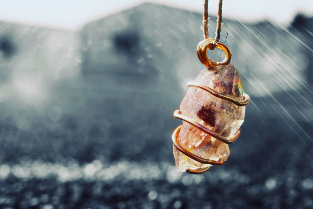 Tibetan Black Quartz in a hanging coiled metal.