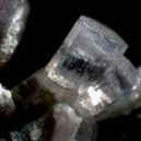 Achroite crystal on a black background