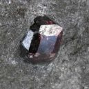 Almandine Spinel embedded on a rock