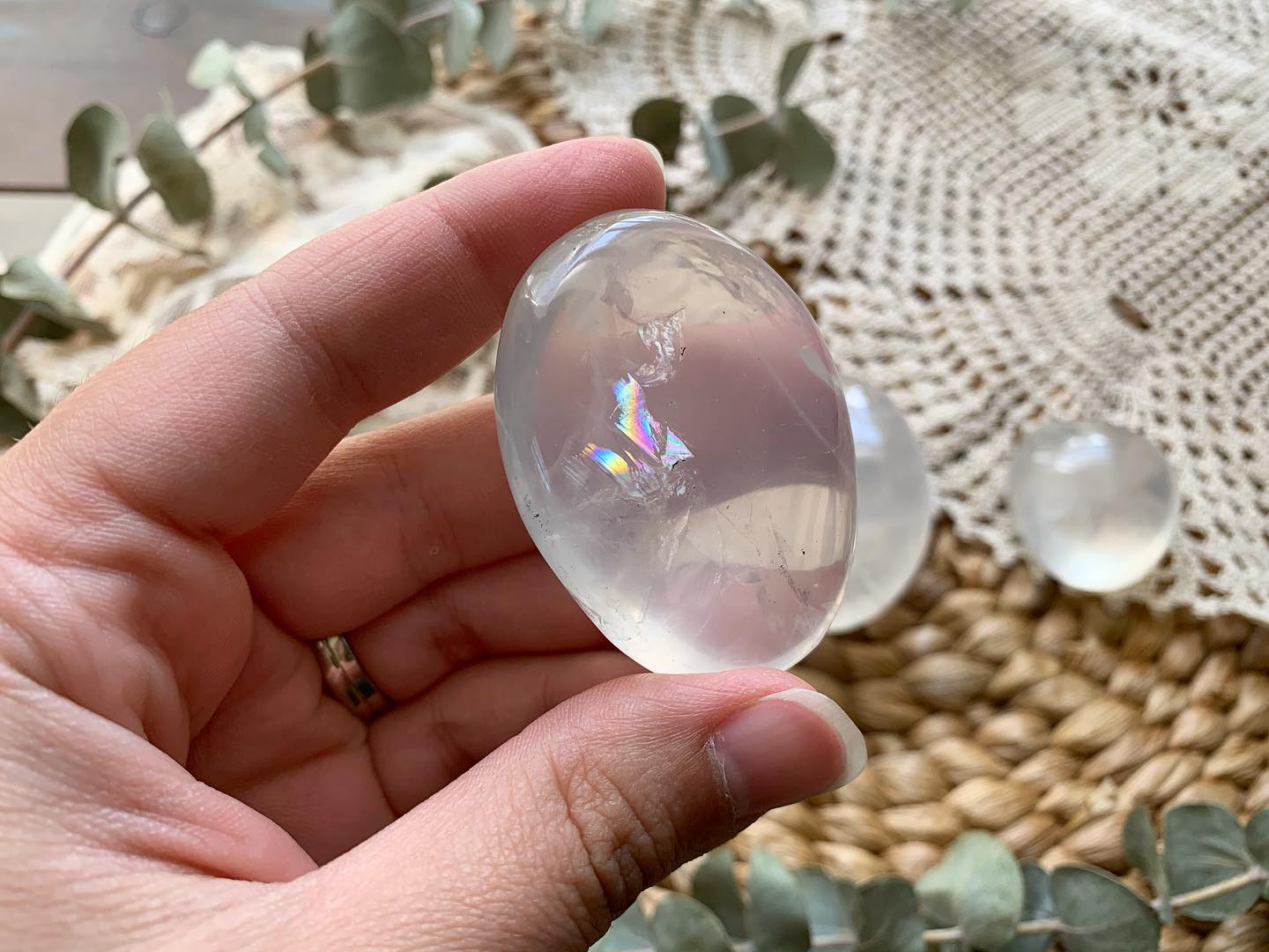 polished girasol quartz being held by a woman hand