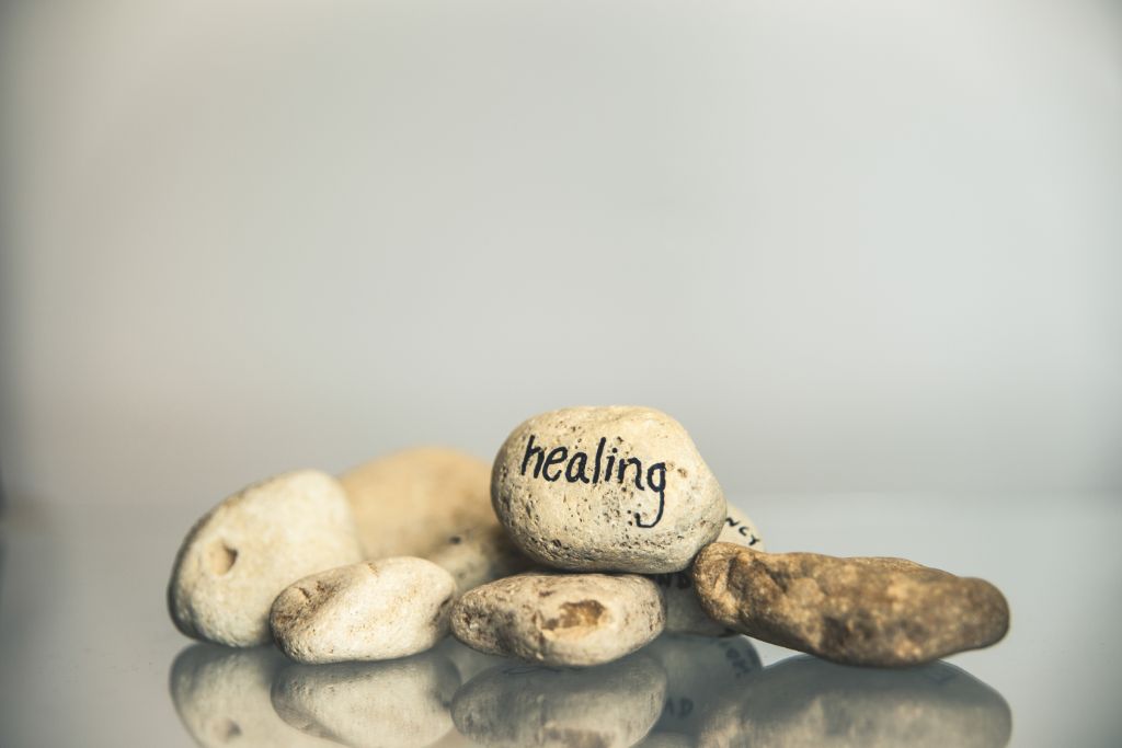 Healing word written on a stone along with other stones.