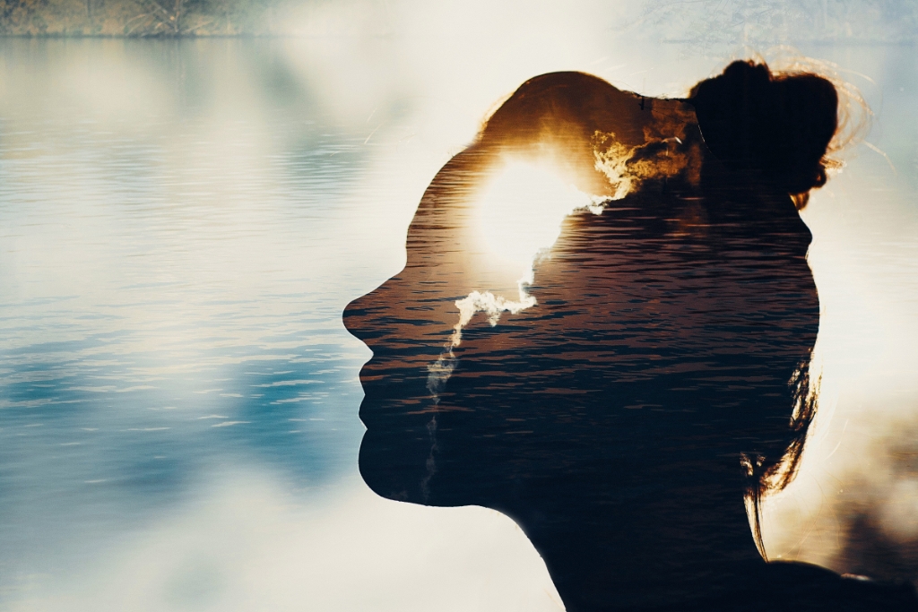 Silhouette of a woman with lake background
