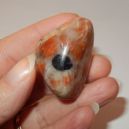 Iolite Sunstone hold by the fingers