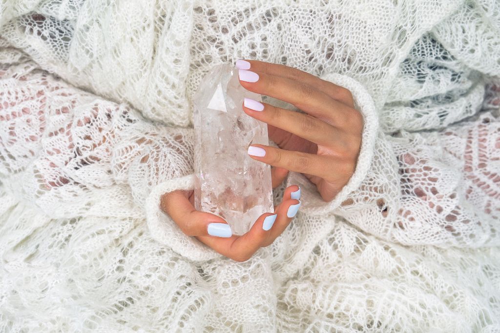 a person holding a crystal 