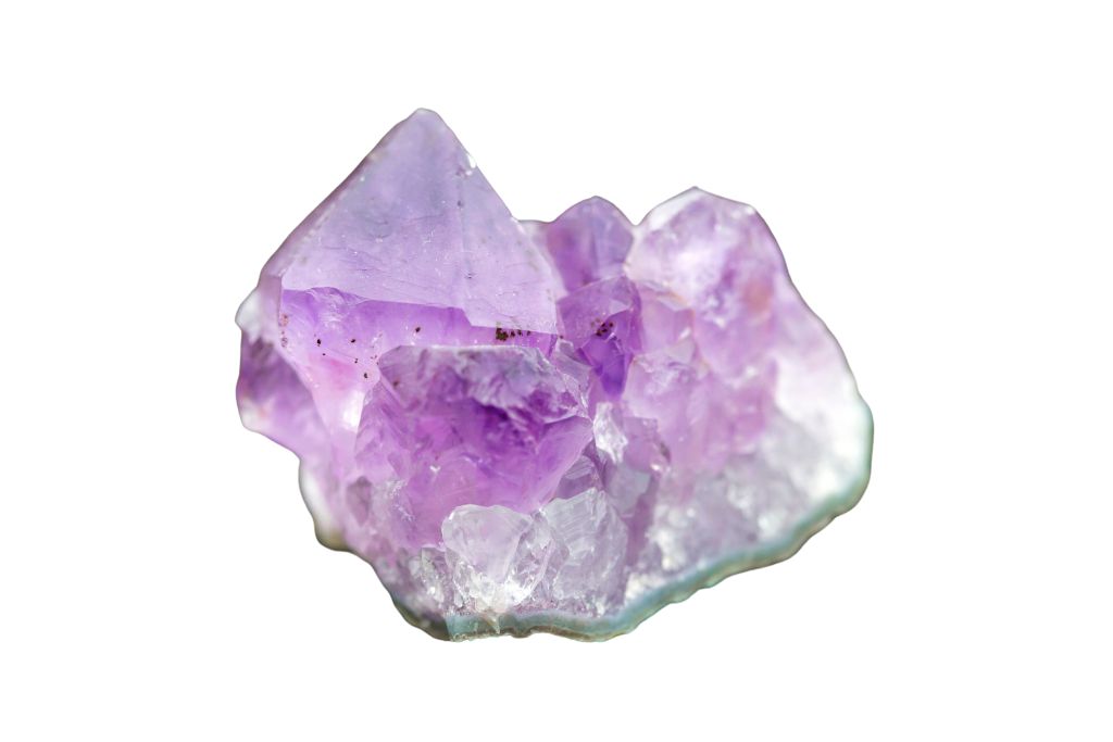A raw amethyst with a white background