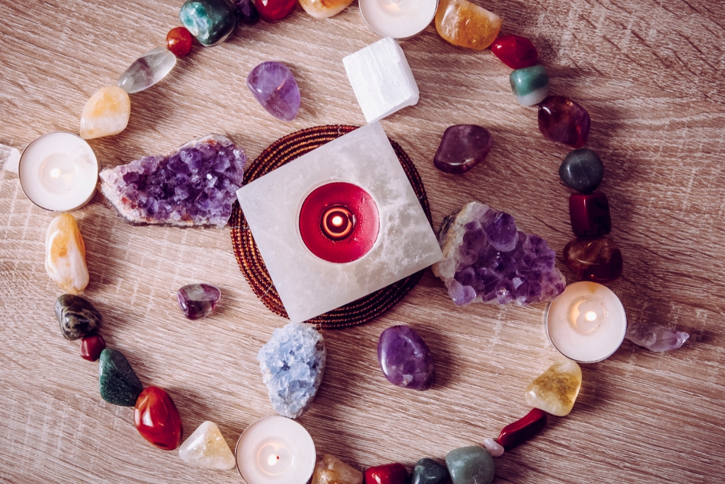 Stones and candles forming a circle and a cross in the middle