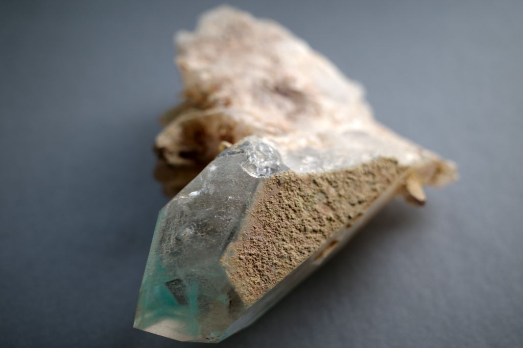 ajoite in quartz on gray table