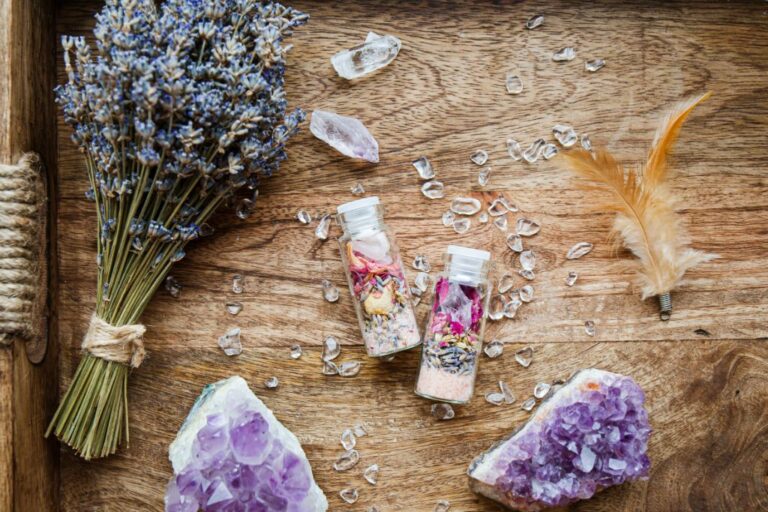 amethyst crystal, a lavender bouquet and a spell jar on a table.